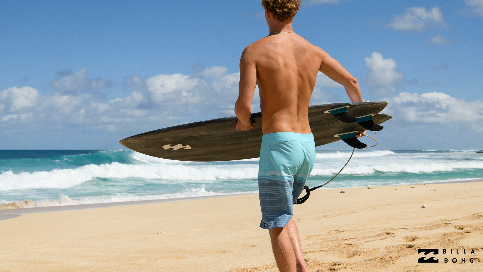 A man wearing a blue Billabong boardshort – Bikini Village