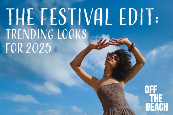 A woman on the beach wearing a brown tube jumpsuit from Off the Beach – Bikini Village